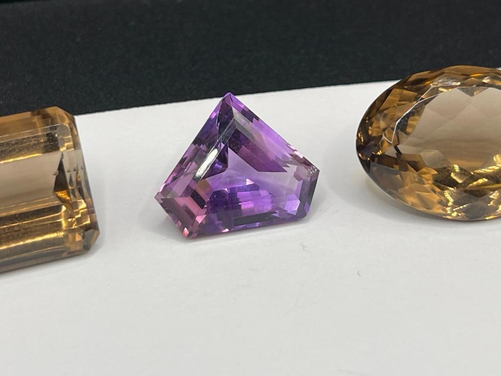 THREE LOOSE GEMSTONES INCLUDING TWO SMOKEY QUARTZ AND AN AMETHYST - 3