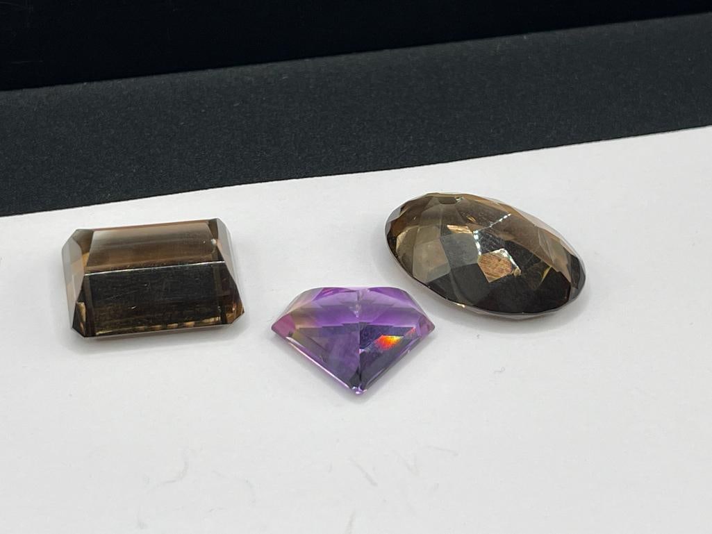 THREE LOOSE GEMSTONES INCLUDING TWO SMOKEY QUARTZ AND AN AMETHYST - 5