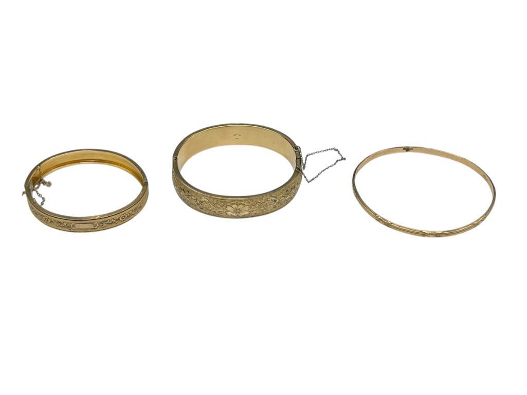 THREE VINTAGE GOLD-FILLED BRACELETS INCLUDING TWO HINGED BRACELETS WITH ETCHED PATTERNS: THIN BANGLE BRACELET HAS BEEN REPAIRED, CLASP IS DAMAGED ON LARGEST BRACELET VARIOUS WRIST WIDTHS UP TO 2 3/4" 