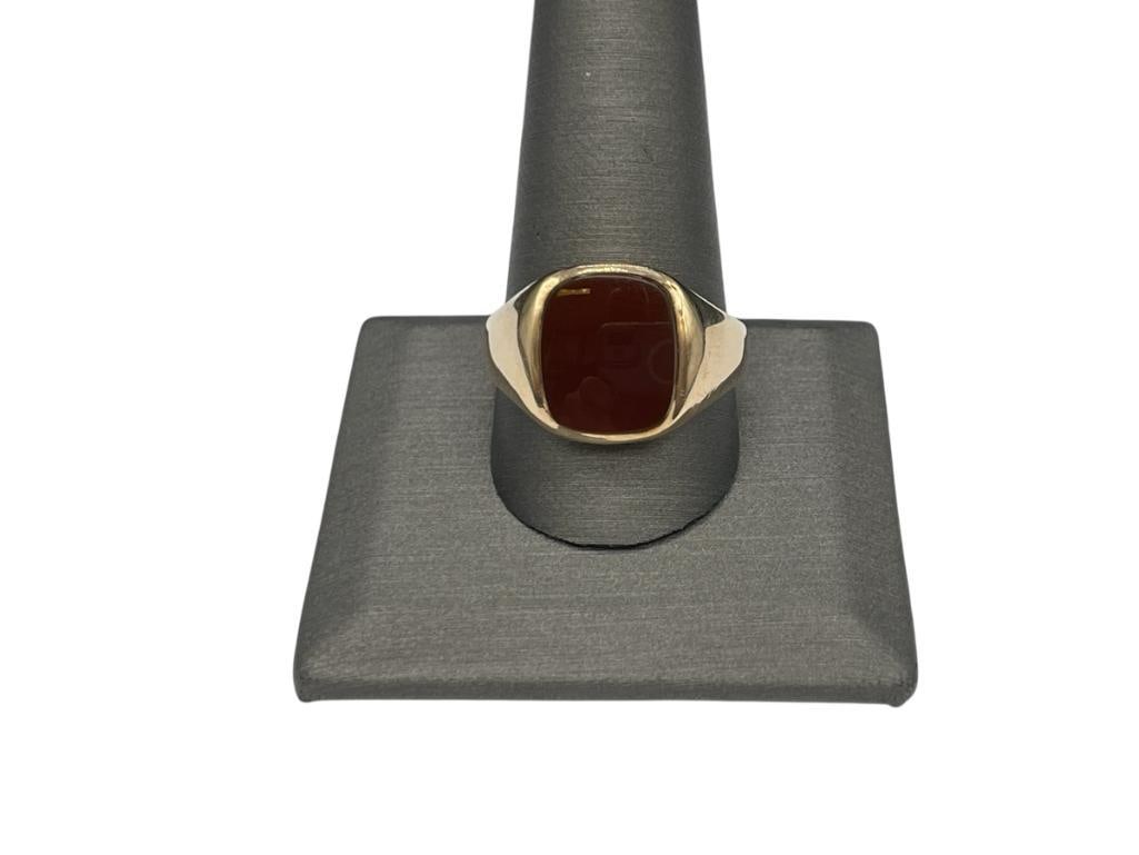 MEN'S 10K YELLOW GOLD CARNELIAN RING: FEATURING SMOOTH FINISH ON BAND AND INSET SQUARE SHAPED CARNELIAN, HALLMARK HAS FADED SIZE 11 1/2, 5/8" FRONT, 6.27 GRAMS