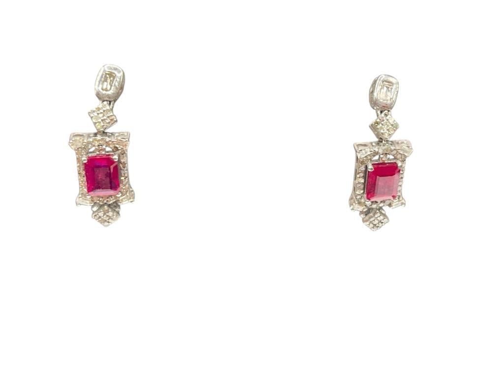 14K WHITE GOLD PLATED STERLING SILVER RUBY AND DIAMOND EARRINGS FEATURING EMERALD CUT RUBIES: VINTAGE STYLE DESIGN FEATURING EMERALD CUT RUBIES ACCENTED BY DIAMONDS, BACKS ARE NOT SILVER, MISSING ONE DIAMOND 1 1/4", 4.00CTTW RUBIES, .50CTTW DIAMONDS, 6.13 GRAMS WITHOUT BACKS