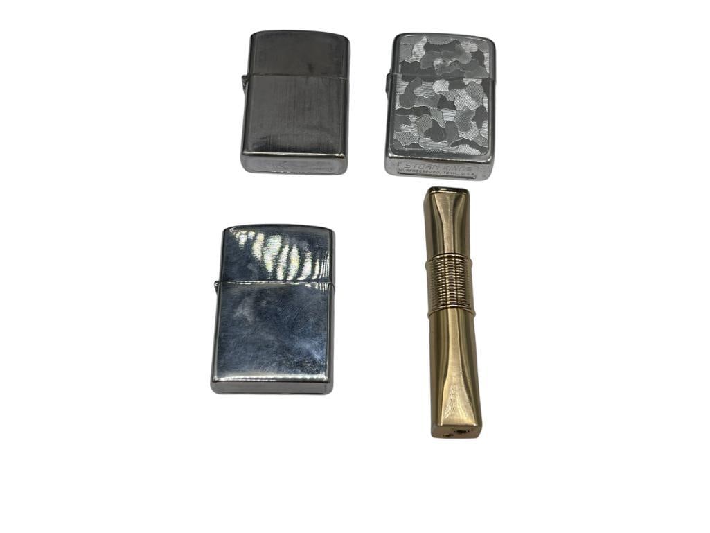 FOUR VINTAGE LIGHTERS INCLUDING ZIPPO STYLE STORM KING AND GOLD TONE LIGHTER: GOLD TONE LIGHTER IS ACCENTED WITH CZ'S BUT IS MISSING ONE LARGEST IS 3 1/4"