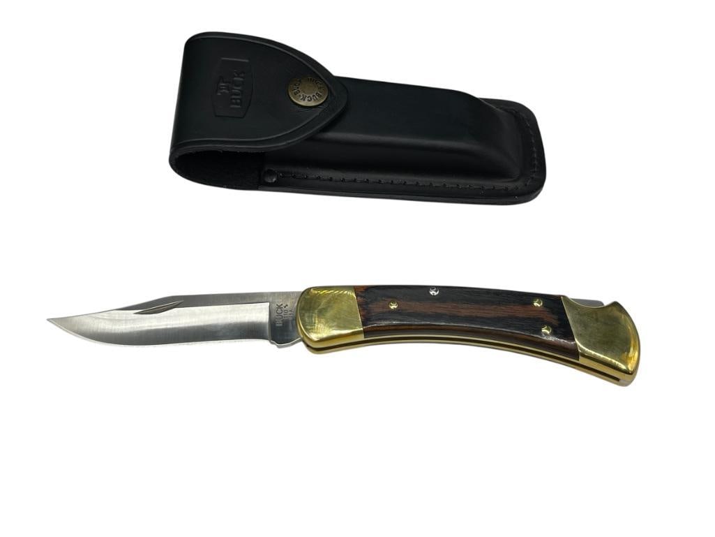 BUCK 110 S FOLDING LOCK BACK KNIFE FEATURING CLIP-POINT BLADE: INCLUDES ORIGINAL LEATHER SHEATH, WOOD AND BRASS HANDLE, LIKE-NEW CONDITION 3 1/2" BLADE, 8 1/2" TOTAL LENGTH