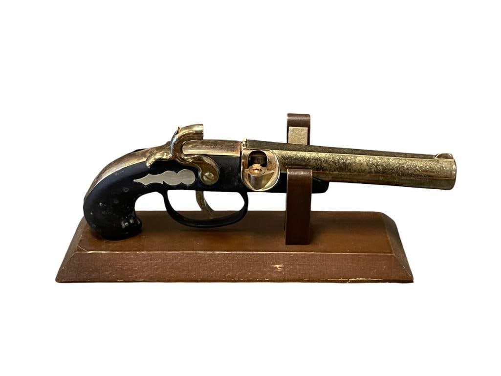 VINTAGE DERRINGER FLINTLOCK PISTOL LIGHTER WITH STAND: BLACK HANDLE WITH BRASS FINISH BARREL 7 1/2" L 