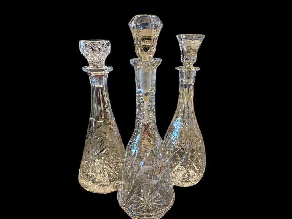 THREE TALL CUT CRYSTL DECANTERS WITH STOPPERS ONE FROM ROYAL GALLERY AND ONE MADE IN CZECHOSLOVAKIA: ONE DECANTER IS NOT MARKED, TWO DECANTERS HAVE ORIGINAL LABELS, BUT ONE IS PARTIALLY LEGIBLE, NO CRACKS OR CHIPS 11 1/2", 12", AND 13" H 