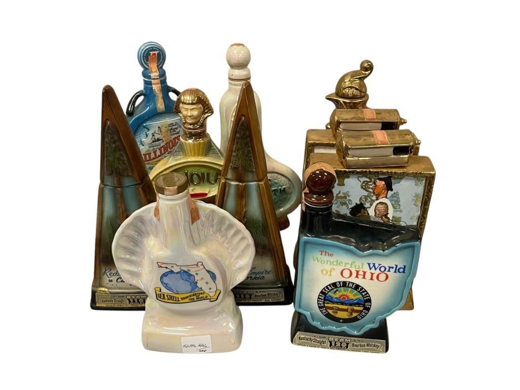 TEN VINTAGE CERAMIC / CHINA COLLECTIBLE DECANTERS MOST MADE BY REGAL CHINA: FLORIDA AND OHIO DECANTERS, CALIFORNIA REDWOODS EMPIRE DECANTERS, MOILA TEMPLE, BING'S 30TH, ILLINOIS, ETC. ONE IS MISSING ITS TOP 9 1/2" UP TO 13" H 