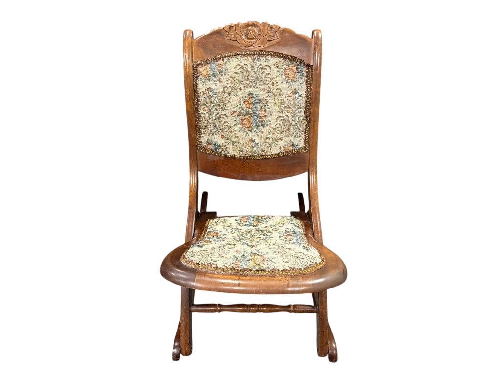 VINTAGE FOLDING ROCKING CHAIR WITH CARVED WALNUT WOOD FRAME AND FLORAL UPHOLSTERY: GOOD CONDITION WITH MINOR FLAWS IN WOOD 17" X 28" X 17" SEAT HEIGHT, 32" SEAT BACK HEIGHT
