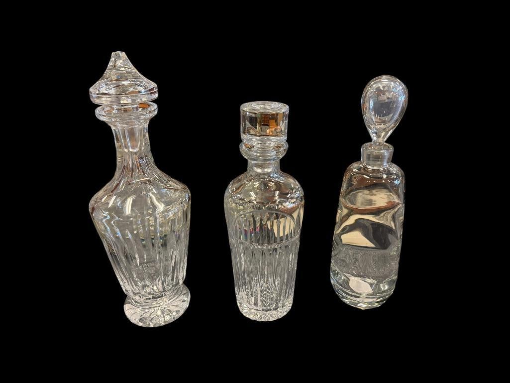THREE ELEGANT CRYSTAL SHIP'S DECANTERS FEATURING VARIOUS DESIGNS: NO CHIPS OR CRACKS, ALL INCLUDE STOPPERS LARGEST IS 12 3/4" 