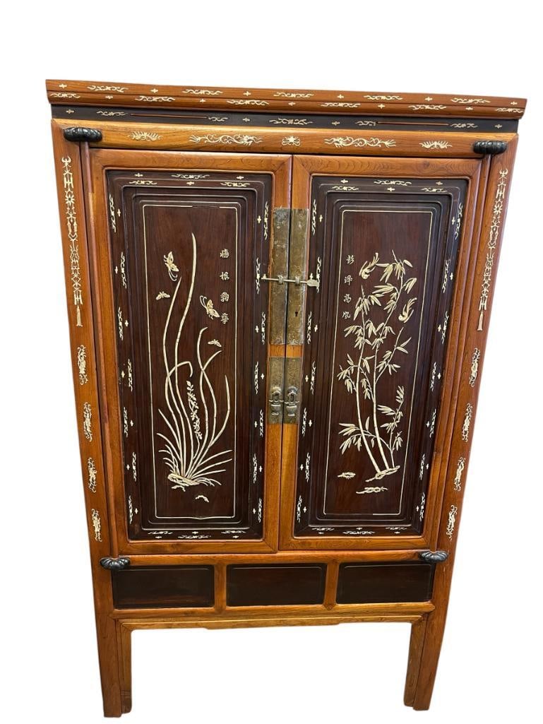 BEAUTIFUL LATE 19TH CENTURY CHINESE WEDDING CABINET WITH INTRICATE INLAY AND OVERLAY DESIGN: HAND CRAFTED CABINET WITH BONE INLAY AND OVERLAY, DESIGN OF BAMBOO, BUTTERFLIES, CALLIGRAPHY, DRAGONS, ETC., MADE FROM ELM WOOD, INTERIOR FEATURES SHELF WITH STORAGE DRAWERS, HINGED DOORS WITH BRASS