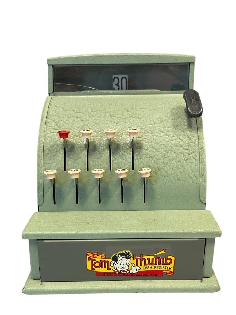 1950'S MID-CENTURY TOM THUMB CHILDRENS TOY MECHANICAL CASH REGISTER WESTERN STAMPING CO.: PRESSED STEEL TOY IN WRINKLE GREEN FINISH, ORIGINAL DECAL PRESENT, ALL BUTTONS FUNCTIONAL, ACRYLIC WINDOW HAS CRACK ON RIGHT EDGE, OVERALL IN GREAT CONDITION 7 1/2' H