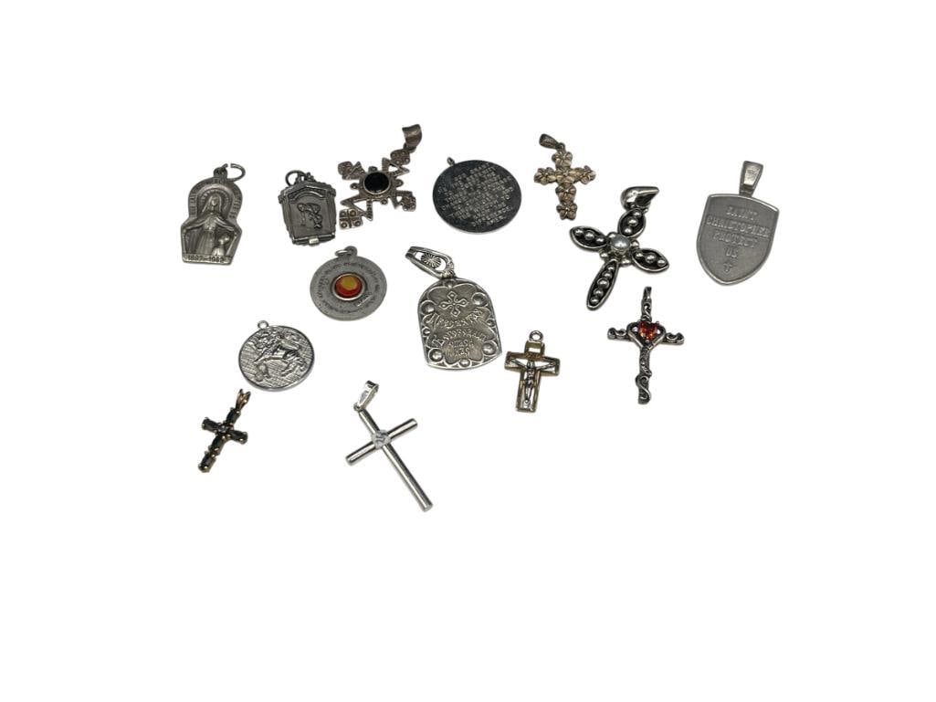 ASSORTED STERLING SILVER RELIGIOUS PENDANTS INCLUDING CROSSES AND ICON CHARMS: 58.81 GRAMS 