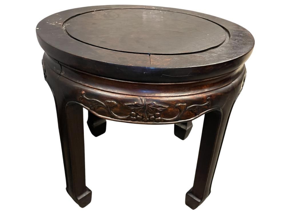 20TH CENTURY CHINESE CARVED ROSEWOOD ROUND SIDE TABEL WITH CARVED SKIRT: FRUIT AND LEAF CARVED SKIRT, MARKED MADE IN HONG KONG ON THE BOTTOM 18" ROUND, 16" H 