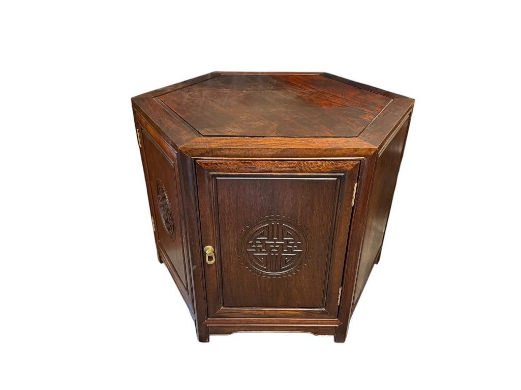 20TH CENTURY ROSEWOOD OCTAGONAL STORAGE TABLE WITH CARVED MEDALLION DOOR: FEATURES SINGLE SHELF INSIDE, TOP HAS FEW STAINS 25 3/4" X 25 3/4" X 22" 