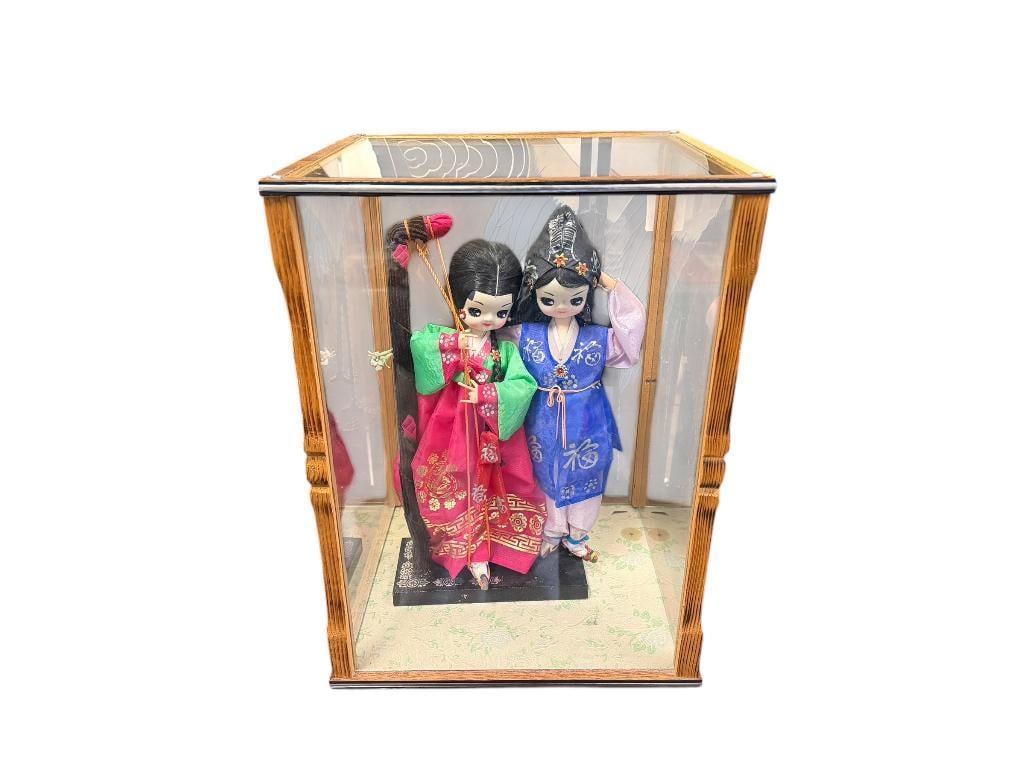 VINTAGE WOOD AND GLASS DOLL DISPLAY WITH TWO CHINESE FABRIC DOLLS WITH HAND PAINTED FEATURES: 13" DOLLS, 11 1/2" X 10" X 16" DISPLAY 