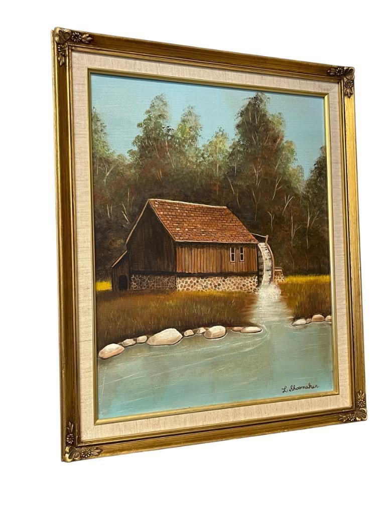 L. SHOEMAKER ORIGINAL ACRYLIC ON CANVAS PAINTING OF A WATERMILL: ART DEPICTS A WATERMILL WITH THICK MATURE TREE LINE IN THE BACKGROUND, SIGNED LOWER RIGHT, FRAMED 19 1/2" X 23 1/2" FRAME 