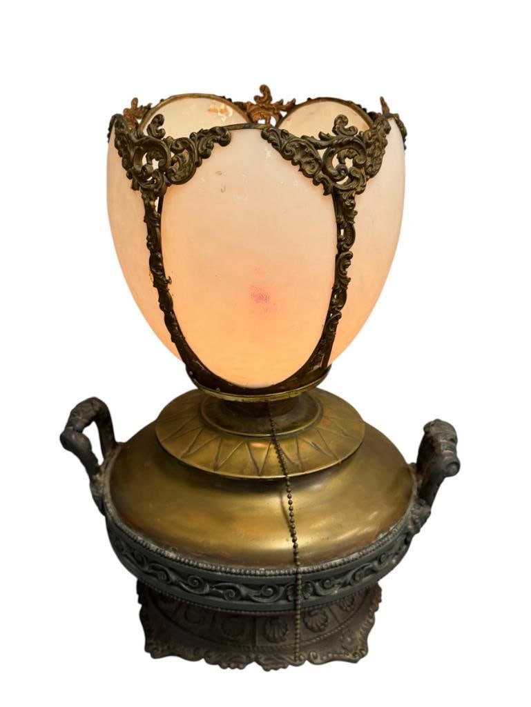 ANTIQUE BRADLEY & HUBBARD ART NOUVEAU STYLE ORNATE PARLOR LAMP WITH ENCASED GLASS SHADE: MARKED B&H ON THE ORNATE CAST IRON BASE, ORNATE TRIM AND HANDLES AROUND THE BRASS FONT, HAS BEEN CONVERTED TO ELECTRIC, NO CRACKS ON THE FIVE PANEL GLASS SHADE, TESTED +, IN GREAT CONDITION FOR