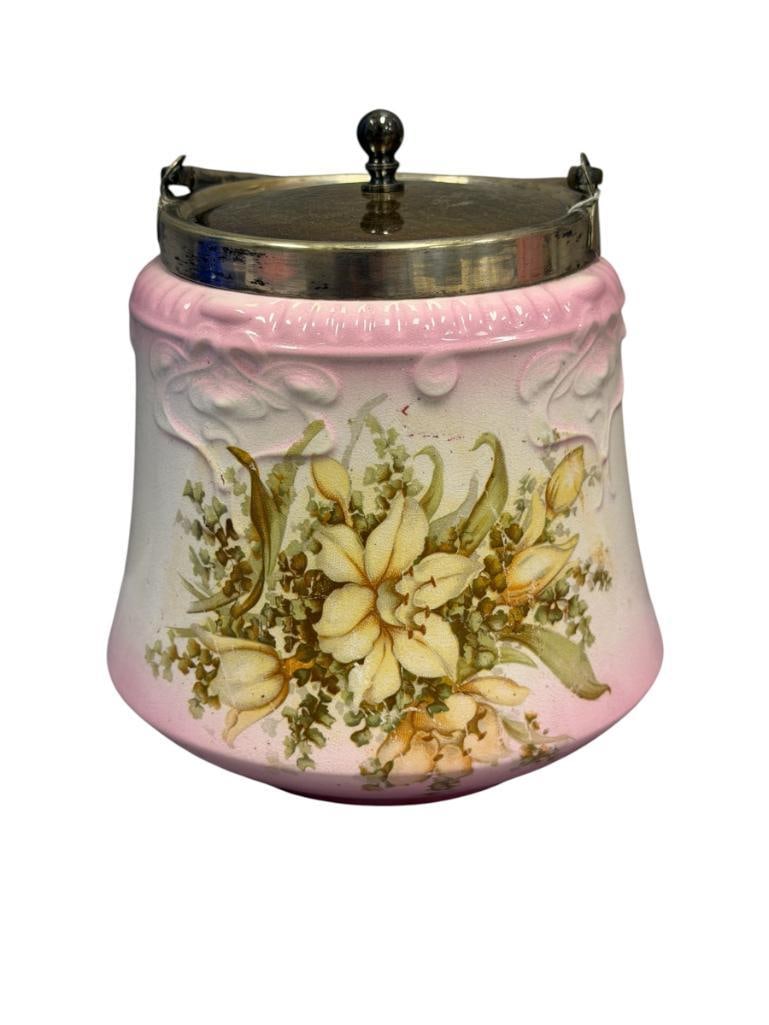 ANTIQUE BRIDGWOOD ENGLISH CHINA EMBOSSED BISCUIT BARREL / JAR WITH FLORAL DESIGN: FEATURES SILVERPLATE RIM WITH HANDLE AND TOP, MARKED ON THE BOTTOM, SHOWS LIGHT WEAR TO DESIGN, NO CHIPS OR CRACKS 6 1/4" H