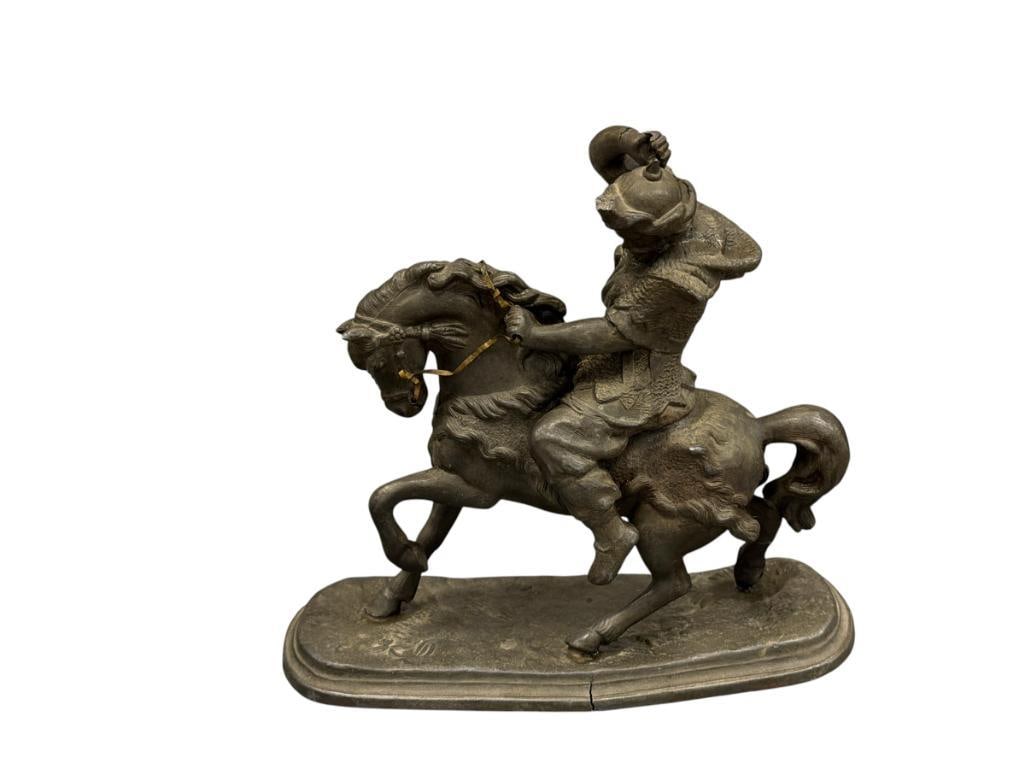 EARLY 1900'S METAL SPELTER FIGURE OF A MAN ON HORSEBACK: FIGURE HAS DAMAGE ALONG THE MANS WRIST, NECK, AND BASE 7 3/4" H