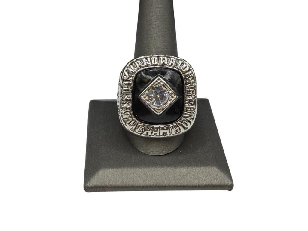 1967 OAKLAND RAIDERS DARYLE LAMONICA AFL CHAMPIONSHIP REPLICA RING: STAINLESS STEEL WITH BLACK ENAMEL AND CLEAR STONES, FEATURING DETAILS ON EACH SIDE SIZE 12, 1 1/8" FRONT