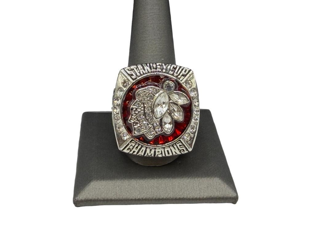 2013 CHICAGO BLACKHAWKS JONATHAN TOEWS NHL STANLEY CUP CHAMPIONSHIP REPLICA RING: FEATURING ELABORATE STAINLESS STEEL DESIGN WITH ENAMEL AND CLEAR STONES SIZE 12 1/2, 1 1/4" FRONT