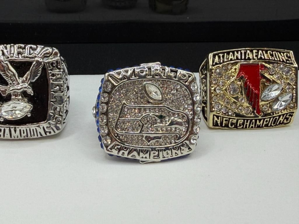 THREE NFL CHAMPIONSHIP REPLICA RINGS INCLUDING SEATLE SEAHAWKS SUPER BOWL REPLICA FROM 2013 - 2