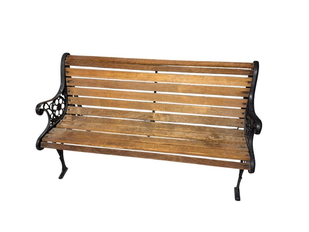 RUSTIC WOOD BENCH FEATURING BLACK CAST IRON LEGS WITH ORNATE DETAILS WITH LIONS AND FLORAL PATTERN (1 of 6)