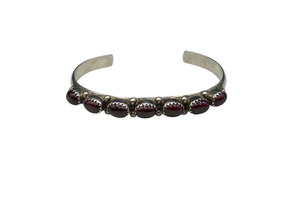 VINTAGE NAVAJO STERLING SILVER ARTIST SIGNED RED CABOCHON STONE CUFF BRACELET: SIGNED BY ARTIST "S" 2 1/4" CUFF WRIST WIDTH X 1/4" THICK, 7MM STONES, 16.41 GRAMS
