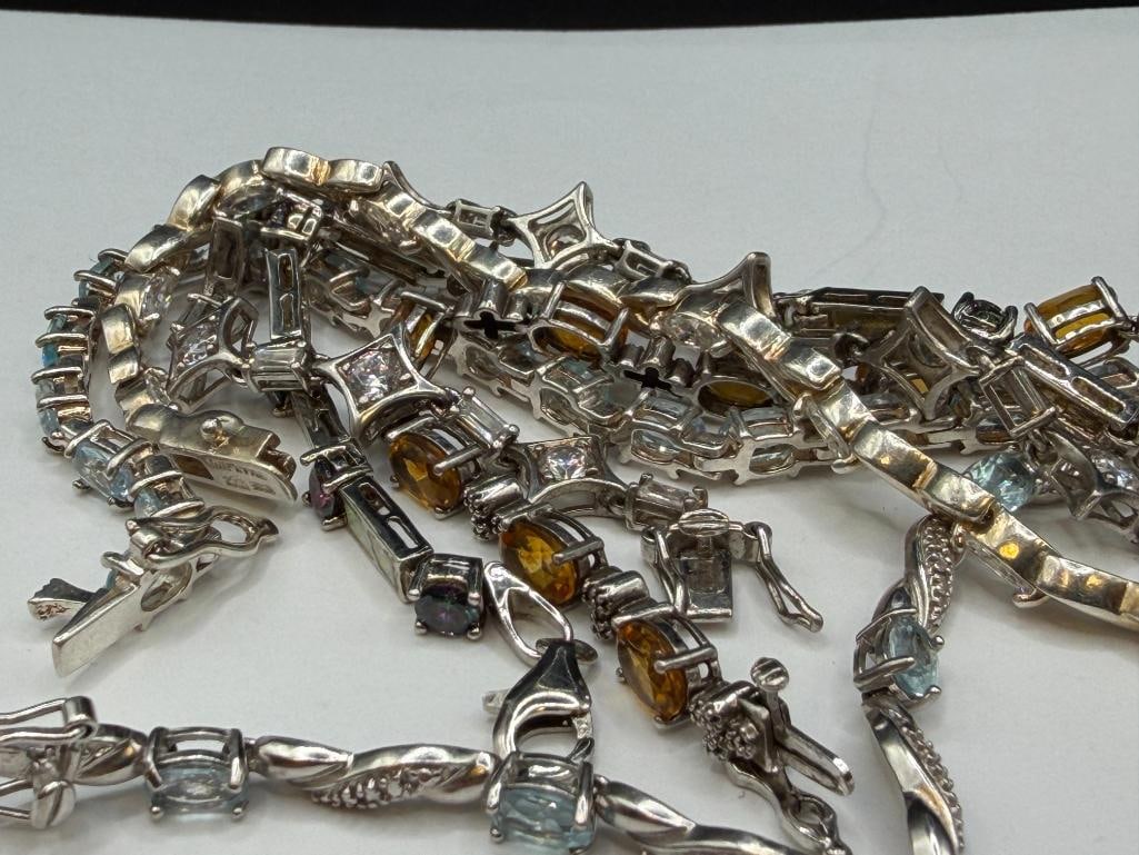 SIX STERLING SILVER TENNIS BRACELETS FEATURING BLUE TOPAZ, CITRINE, CZS, AND OPALITE - 6