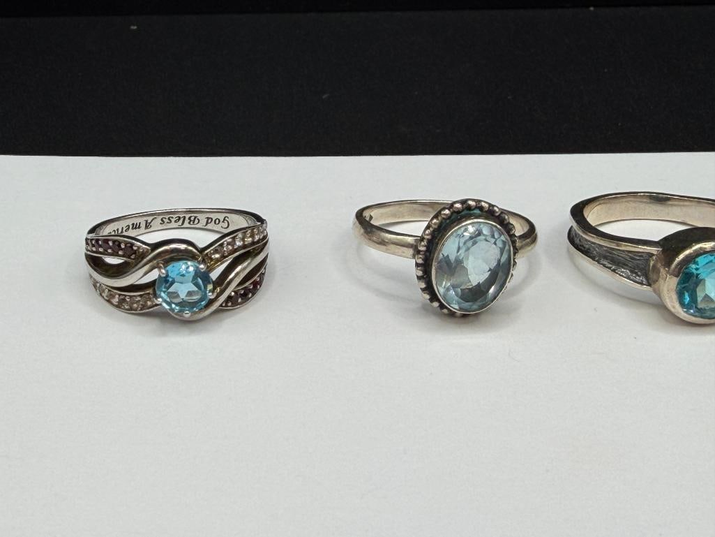 FIVE STERLING SILVER BLUE TOPAZ AND BLUE STONE RINGS - 2