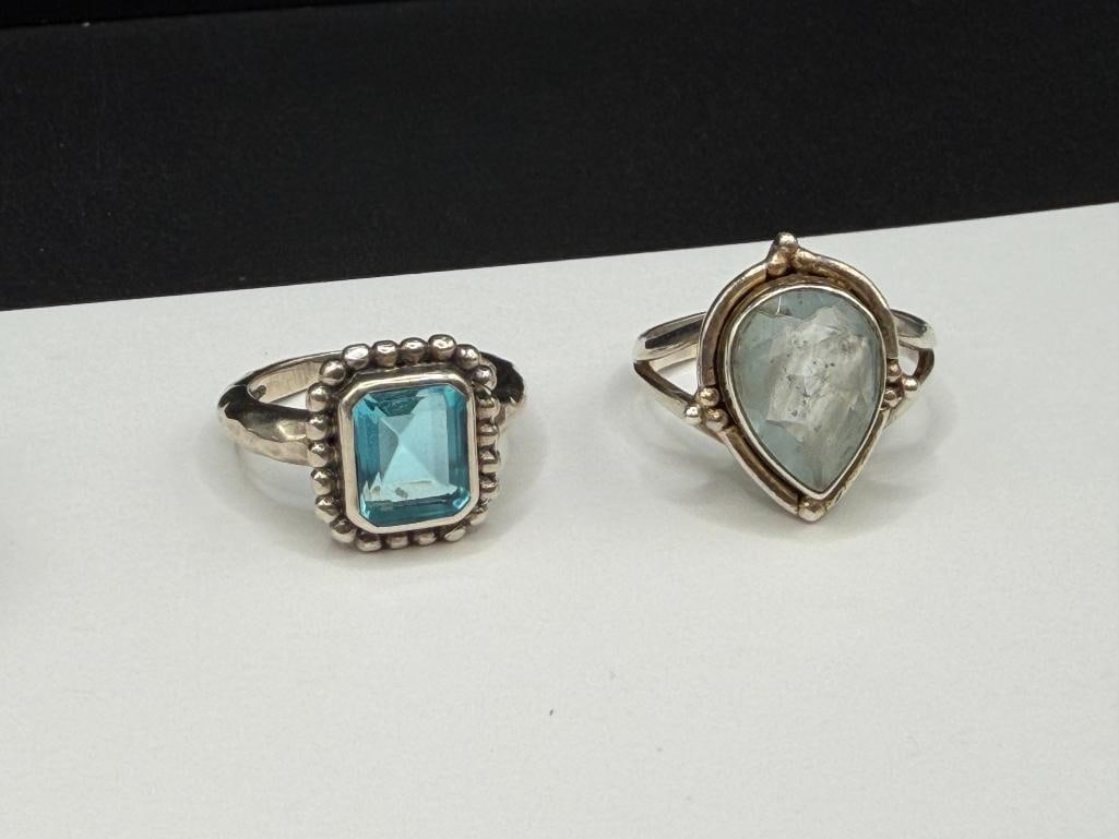 FIVE STERLING SILVER BLUE TOPAZ AND BLUE STONE RINGS - 6