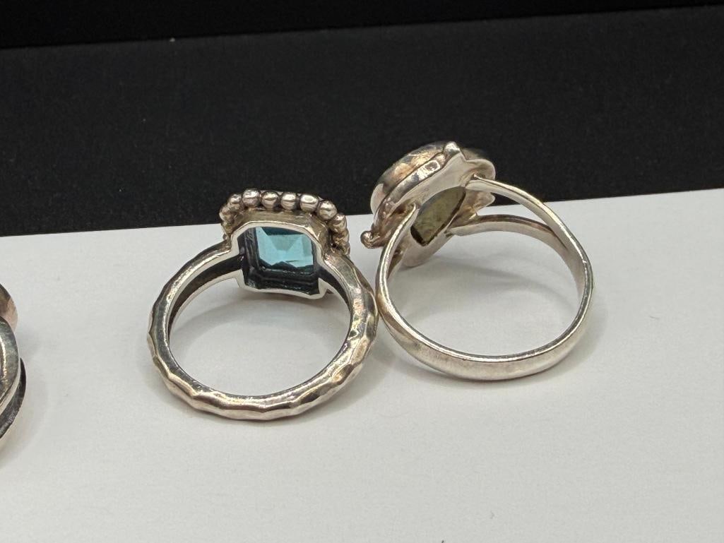 FIVE STERLING SILVER BLUE TOPAZ AND BLUE STONE RINGS - 7