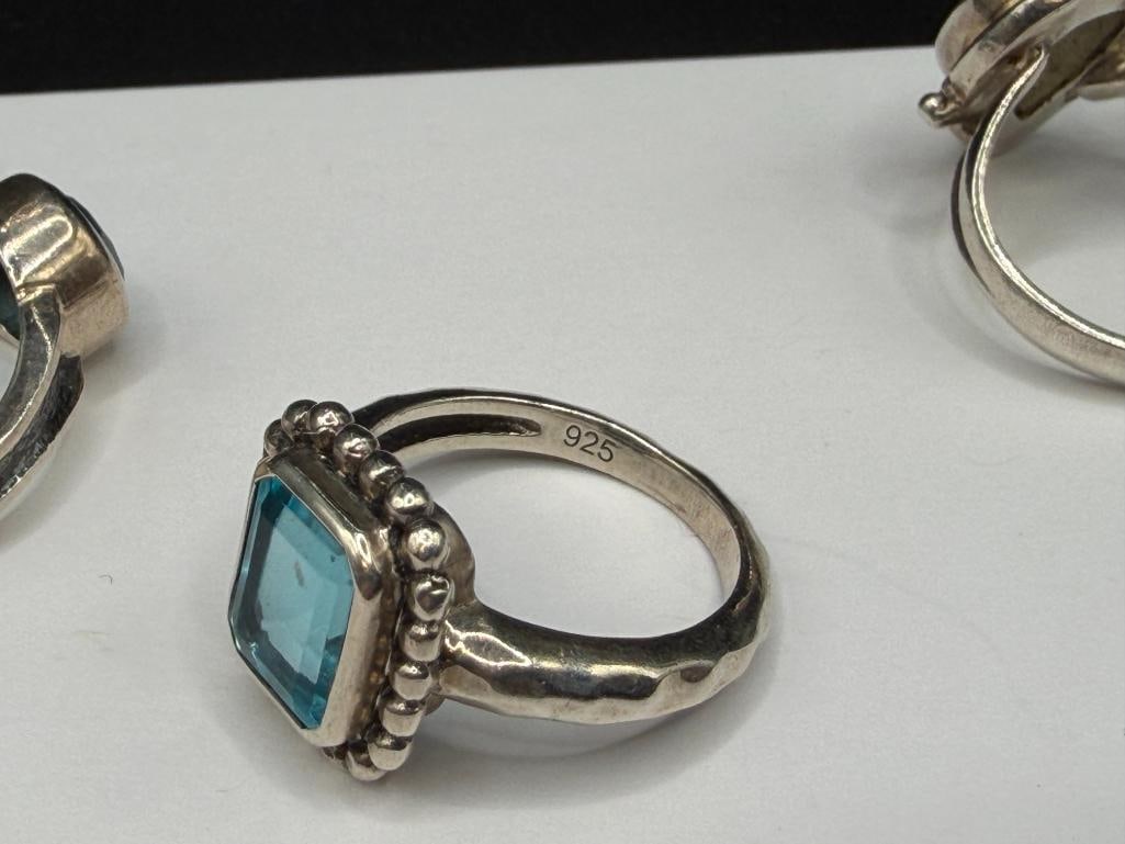 FIVE STERLING SILVER BLUE TOPAZ AND BLUE STONE RINGS - 8