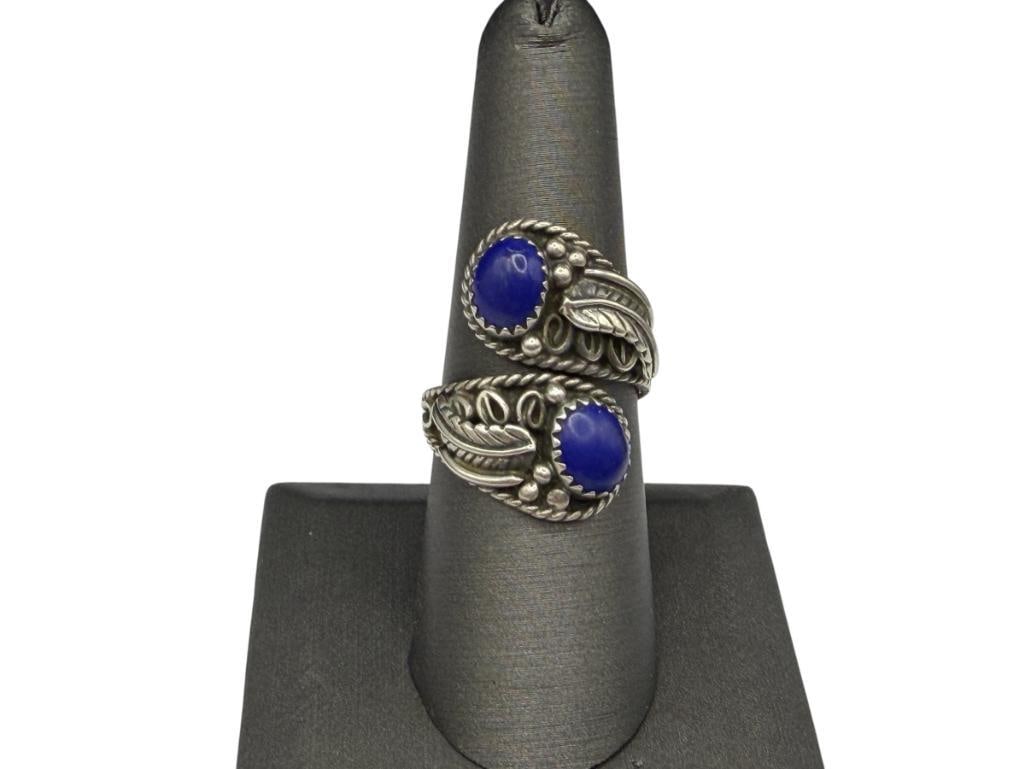 VINTAGE NAVAJO ELSIE YAZZIE STERLING SILVER LAPIS BYPASS RING WITH ORNATE TOOLED SILVER DESIGN: SIGNED "EY" BY ARTIST, FEATURING TWO OVAL CABOCHON LAPIS SET AT EACH TIP OF RING SIZE IS ADJUSTABLE BUT CLOSE TO 9, 1 1/16" FRONT