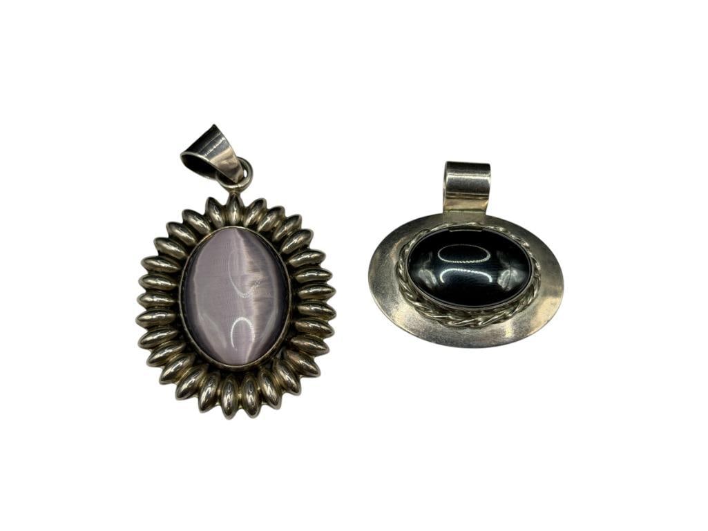 TWO VINTAGE STERLING SILVER STONE PENDANTS INCLUDING PETER VAN HORNE HEMATITE AND PURPLE MOONSTONE: MOONSTONE IS MARKED WITH CLASSIC TAXCO MEXICO MARKINGS, OTHER FEATURES "VHC" IN TRIANGLE HALLMARKED LARGEST IS 2 3/8", 47.84 GRAMS TOTAL 