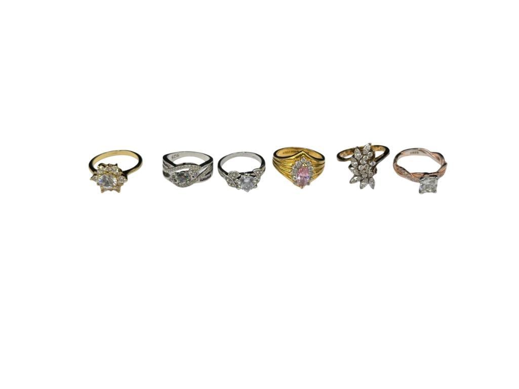 SIX GOLD TONE AND SILVER TONED FASHION RINGS FEATURING STATEMENT DESIGNS AND ELABORATE CZ'S: NONE ARE SILVER, GREAT VARIETY OF COCKTAIL STYLE RINGS AND MORE VARIOUS SIZES