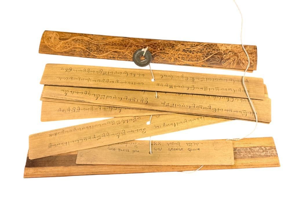 LONTAR PALM LEAF MANUSCRIPT FROM BALI, INDONESIA FEATURES TEXT AND ILLUSTRATIONS OF RAMAYANA STORY: EIGHT PAGE MANUSCRIPT WITH TEX AND ILLUSTRATIONS, ILLUSTRATIONS ARE CARVED INTO THE LEAVES BACK OF EACH LEAF SHOWS TEXT, BOUND BY CARVED WOOD COVERS FEATURING DRAGONS, IN NEAR EXCELLENT CONDITION 10