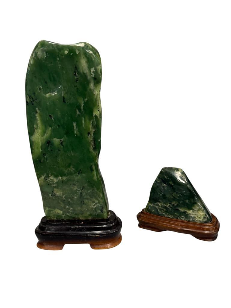 POLISHED FREE FORM GREEN STONE SCULPTURES / CENTERPIECES: GREEN STONES WITH BLACK AND WHITE COLORING, SEMI-POLISHED MOUNTED ON WOODEN BASES 4 1/2" AND 12 1/2" H