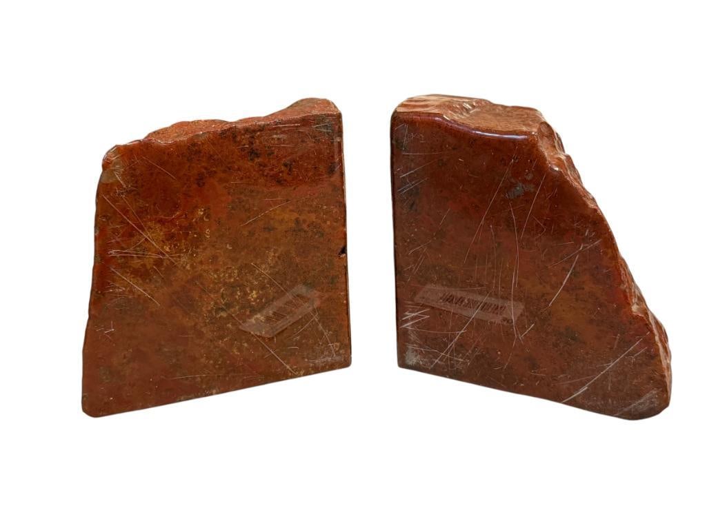 PAIR OF GEOLOGICAL SPECIMEN BOKENDS: BRICK RED IN COLOR, ONE SIDE IS SMOOTH, OTHER SIDES HAVE HEAVY VARNISH OVERALL 11" L 5 3/4" H