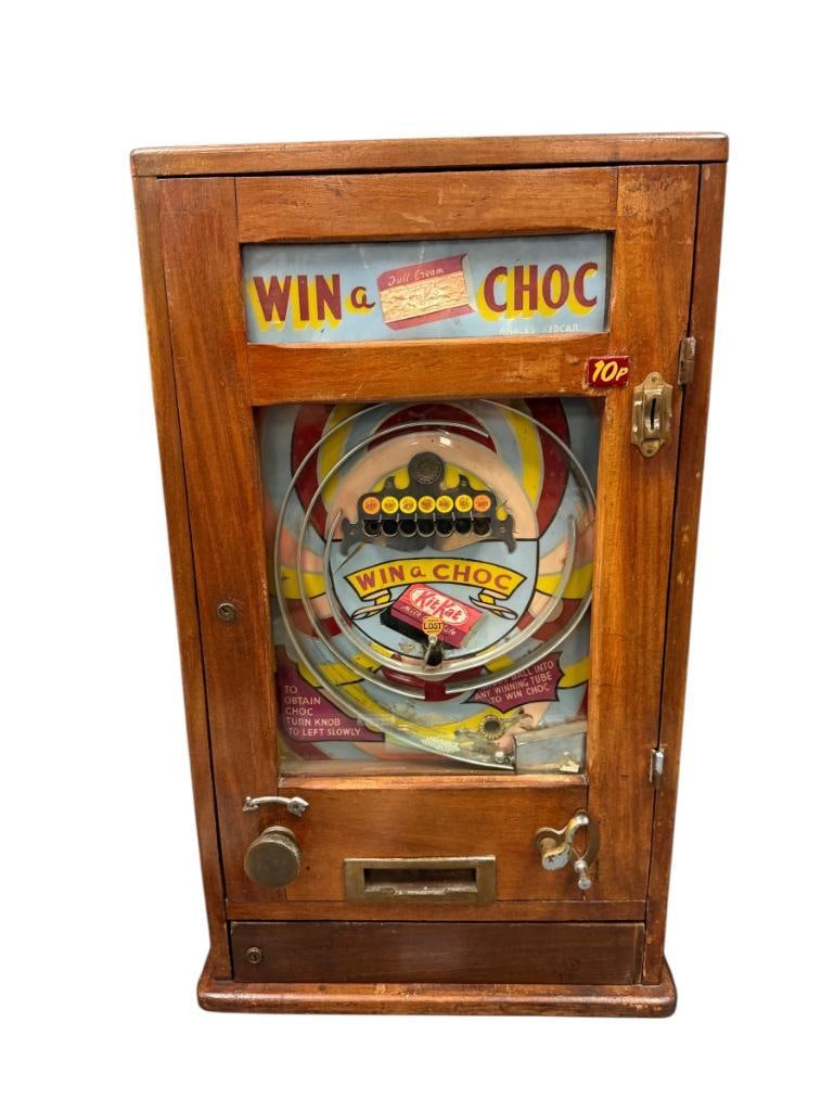 WHALES REDCAR UNITED KINGDOM ALLWIN WIN A CHOC PENNY ARCADE / AMUSEMENT GAME CIRCA 1930'S - 1960'S: WALNUT CASE WITH BRASS HARDWARE, FEATURES COLORFUL BACKGROUND, FRONT DOOR GLASS INTACT, GAME IS FUNCTIONAL, BUT WILL NEED SOME RECONDITIONING 19"X 7" X 31 1/2" 