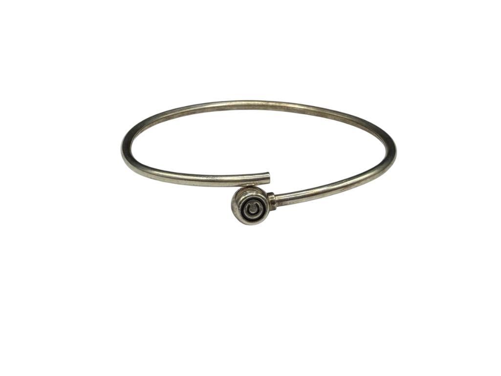 STERLING SILVER BYPASS BANGLE BRACELET WITH COPYRIGHT "C" DESIGN: 2 5/8" WRIST WIDTH, 3/8" FRONT, 9.63 GRAMS