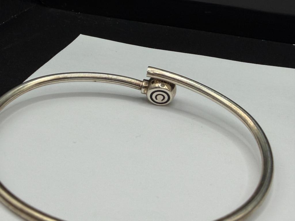 STERLING SILVER BYPASS BANGLE BRACELET WITH COPYRIGHT "C" DESIGN - 6
