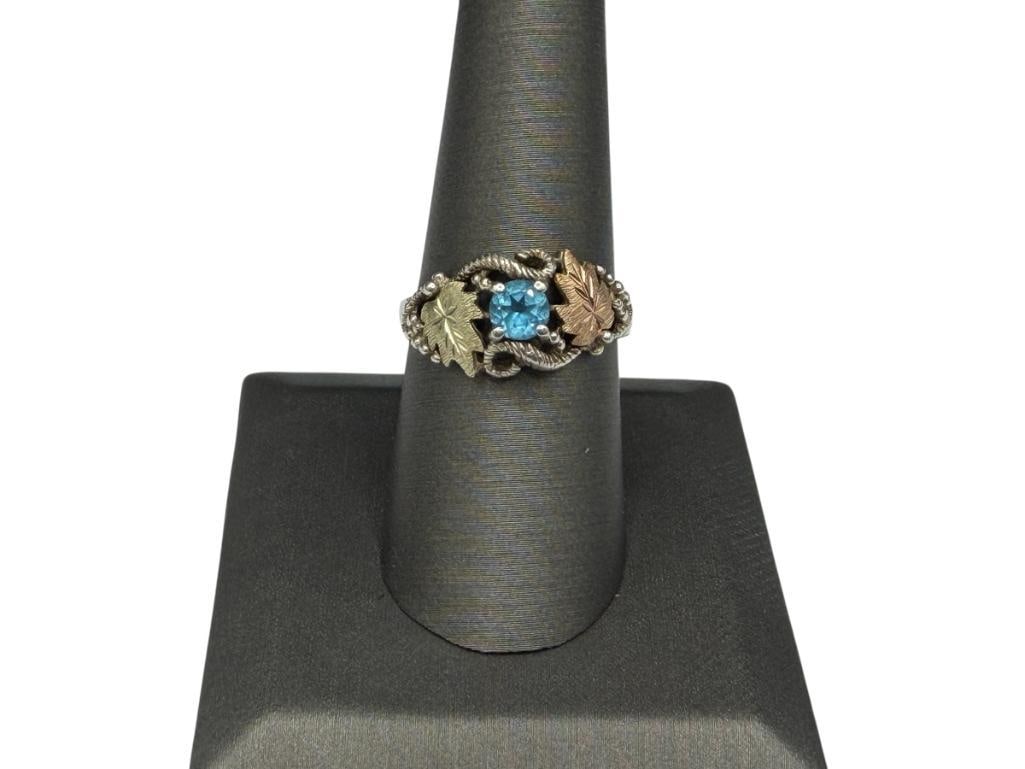 STERLING SILVER AND 10K GOLD LEAF ACCENTED BLUE TOPAZ FASHION RING: SIMILAR TO BLACK HILLS DESIGNS SIZE 8 1/4, 3/8" FRONT, 2.72 GRAMS