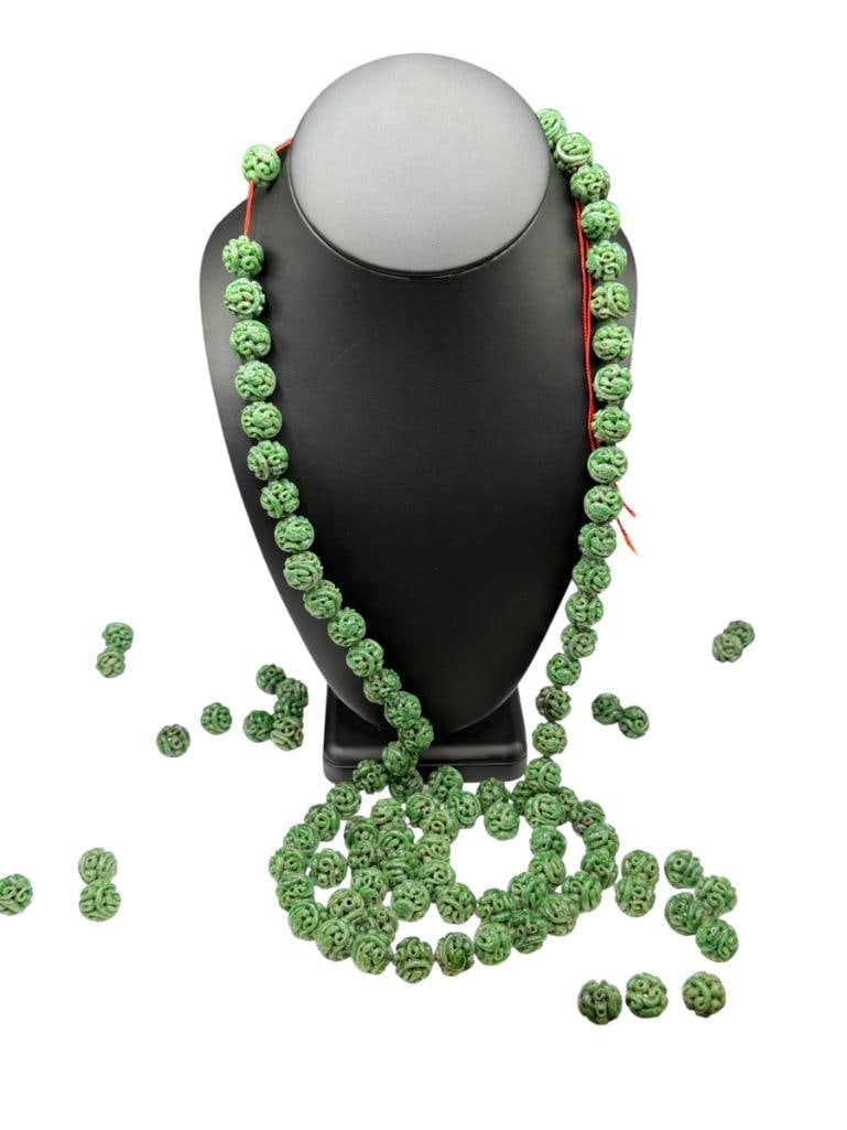 109 CARVED GREEN SPINACH JADEITE BEADS INCLUDING MOST STRUNG ON RED THREAD: UNIQUELY CARVED ASIAN DESIGN BEADS STRAND IS 40", 13MM BEADS