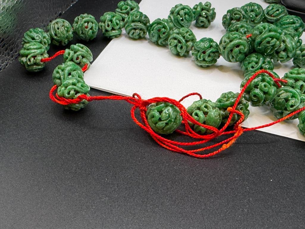 109 CARVED GREEN SPINACH JADEITE BEADS INCLUDING MOST STRUNG ON RED THREAD - 6