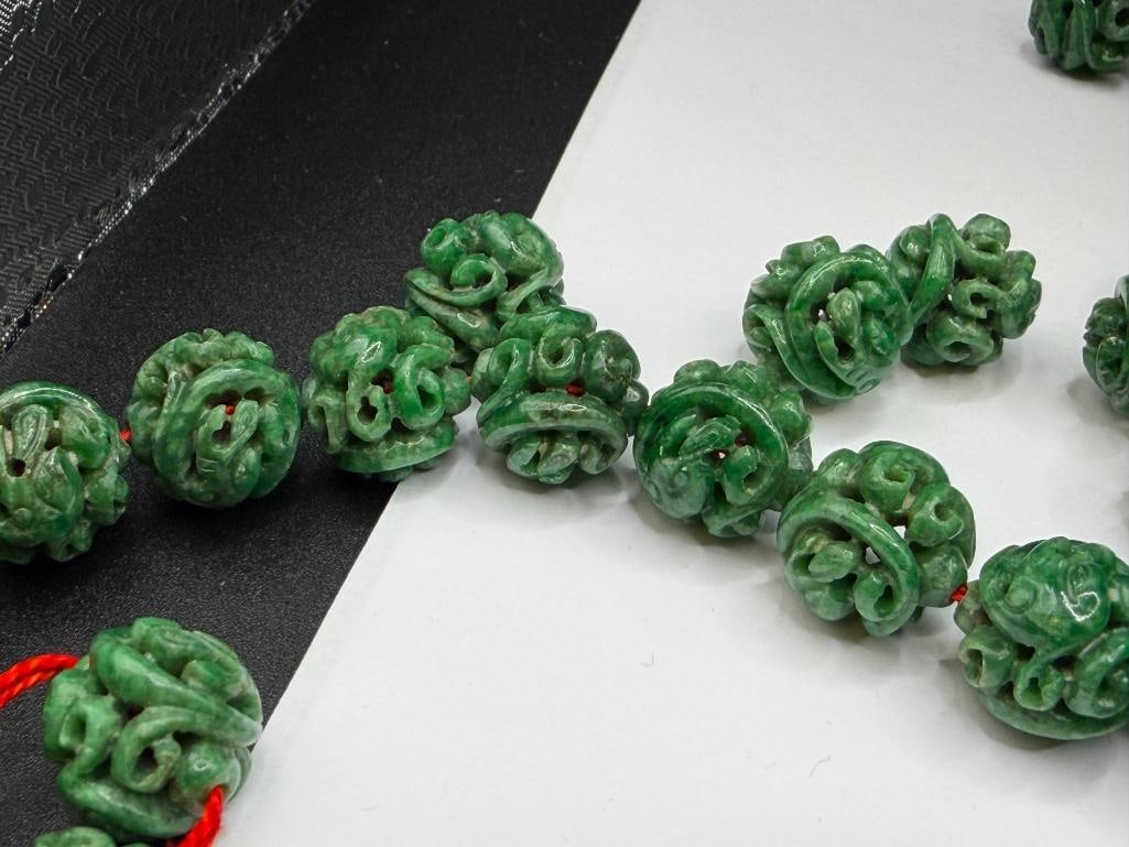 109 CARVED GREEN SPINACH JADEITE BEADS INCLUDING MOST STRUNG ON RED THREAD - 7