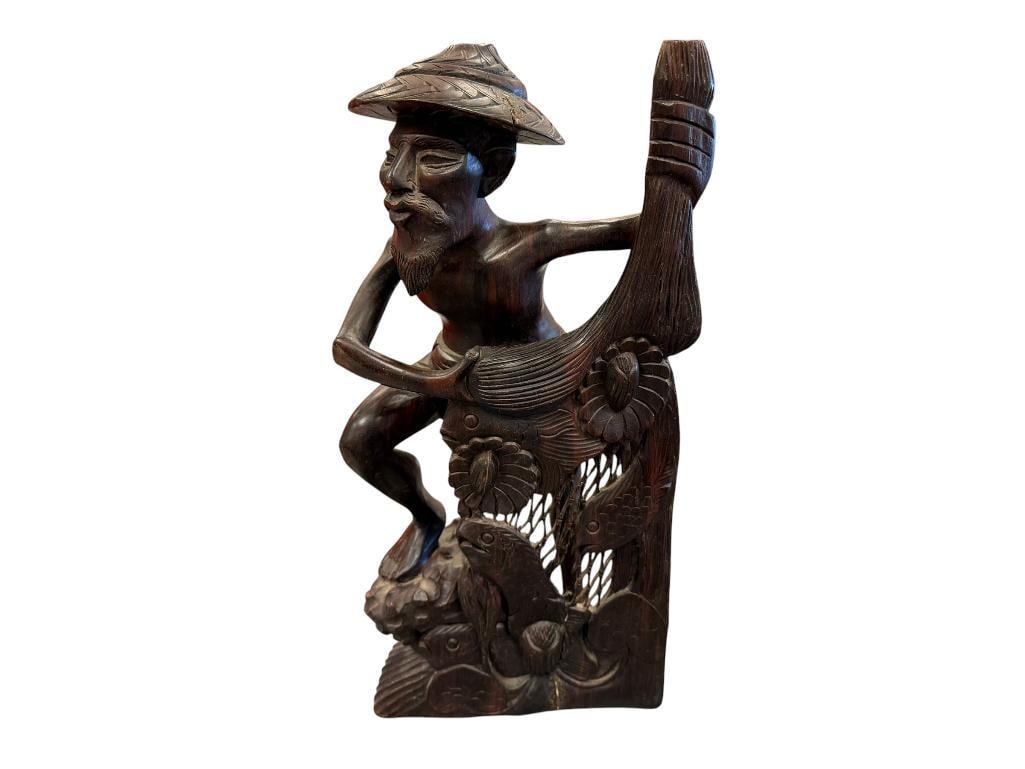 HAND CARVED BALINESE WOODEN STATUE OF A FISHERMAN WITH A NET: CARVED EXOTIC HARDWOOD STATUE, SOME DAMAGE TO NET 16" H