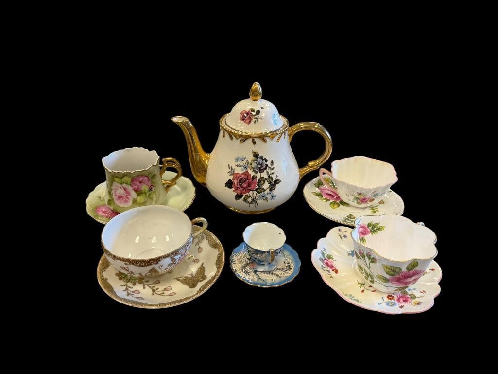 ARTHUR WOOD ENGLISH TEAPOT WITH FIVE DEMIS, CUPS, AND SAUCERS VARIOUS MAKERS: FLORAL DECORATED CUPS AND SAUCERS AND JAPANESE MORIAGE DRAGONWARE DEMI AND SAUCER 8 1/2" TEAPOT