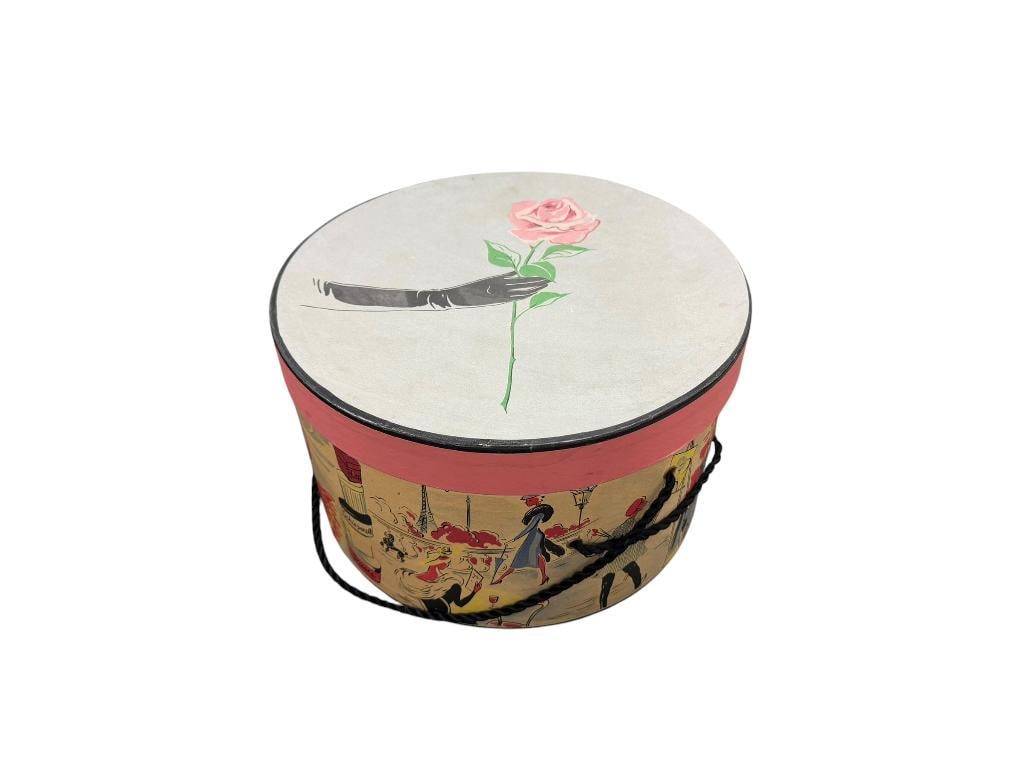 FOUR VINTAGE FLORAL MOTIF LADIES HATS IN FRENCH INSPIRED HAT BOX: EACH HAT FEATURES FLORAL DESIGNS WITH VIBRANT COLORED ARTIFICIAL FLOWERS AND TWO WITH ARTIFICIAL WHITE FLOWERS HAT BOX IS 11" X 6 1/2", HATS ARE VARIOUS SIZES