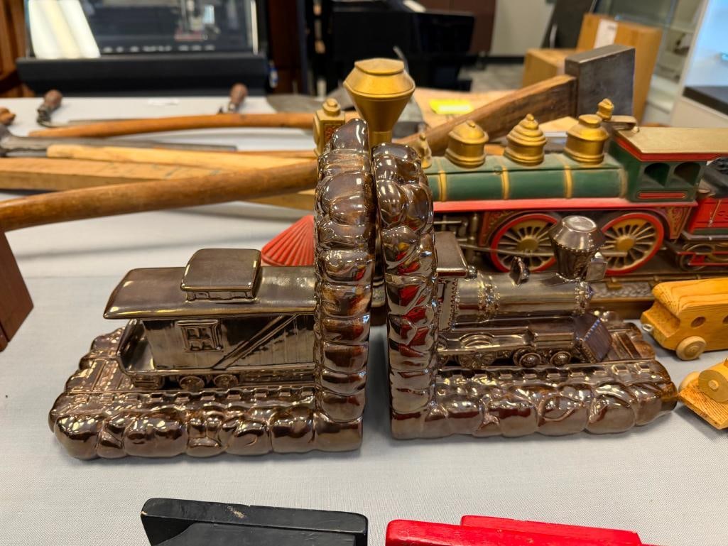 ASSORTED TRAIN COLLECTIBLES INCLUDING CERAMIC BOOKENDS, CARVED WOOD MODEL TRAINS, AND MORE - 12