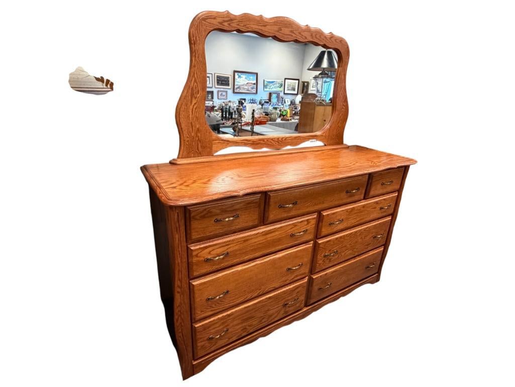 OAK NINE DRAWER DRESSER WITH ATTACHED MIRROR: FEATURES AGED BRASS HARDWARE, DOVETAIL CONSTRUCTED DRAWERS WITH BALL-BEARING SLIDES, SOLID CONSTRUCTION, NO HEAVY WEAR 69" X 22" X 43", MIRROR 55" X 32"